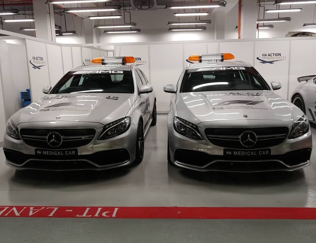 Two silver FIA medical cars parked side by side