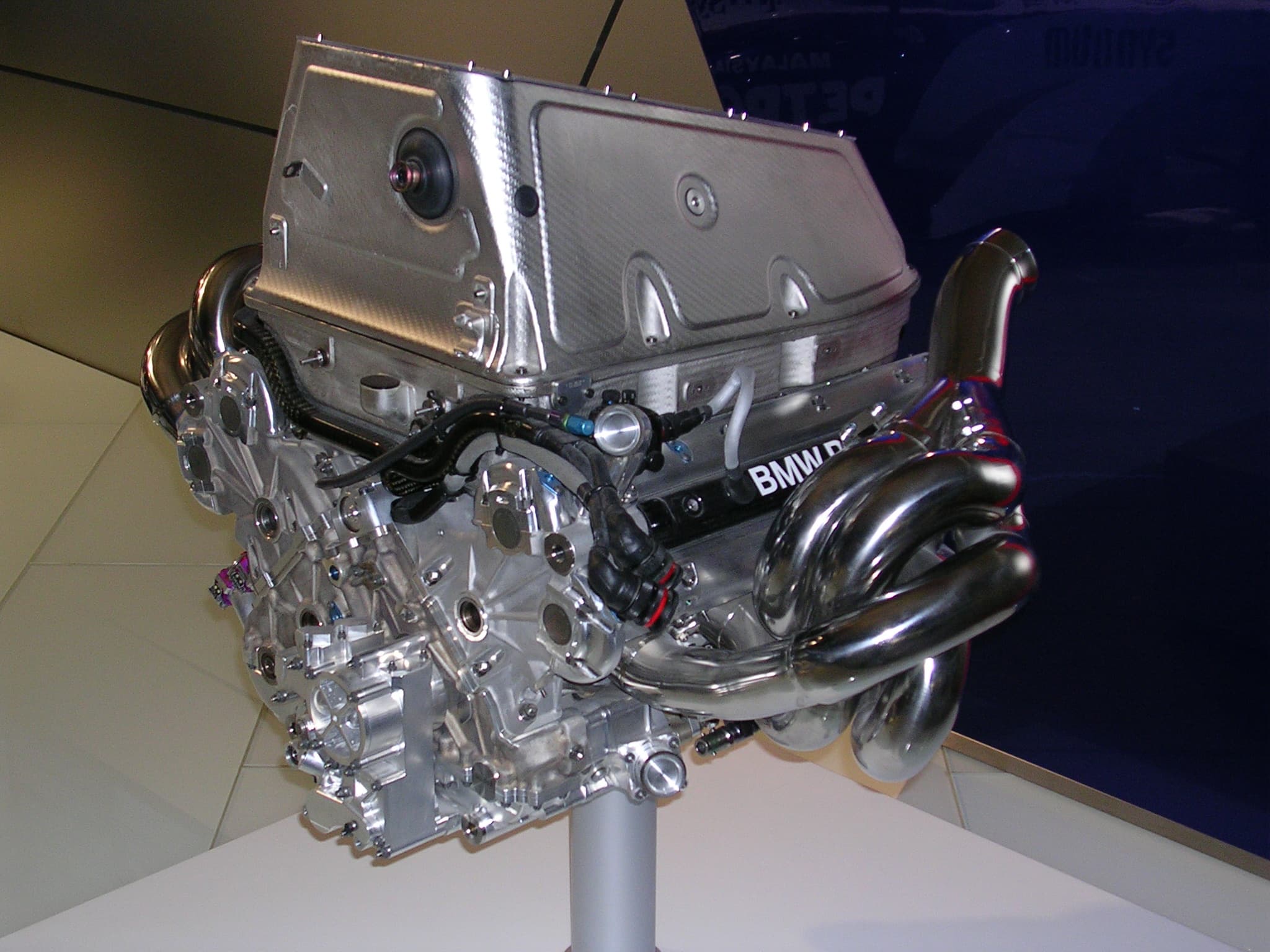 A historic BMW Sauber Formula 1 V8 engine displayed on a stand