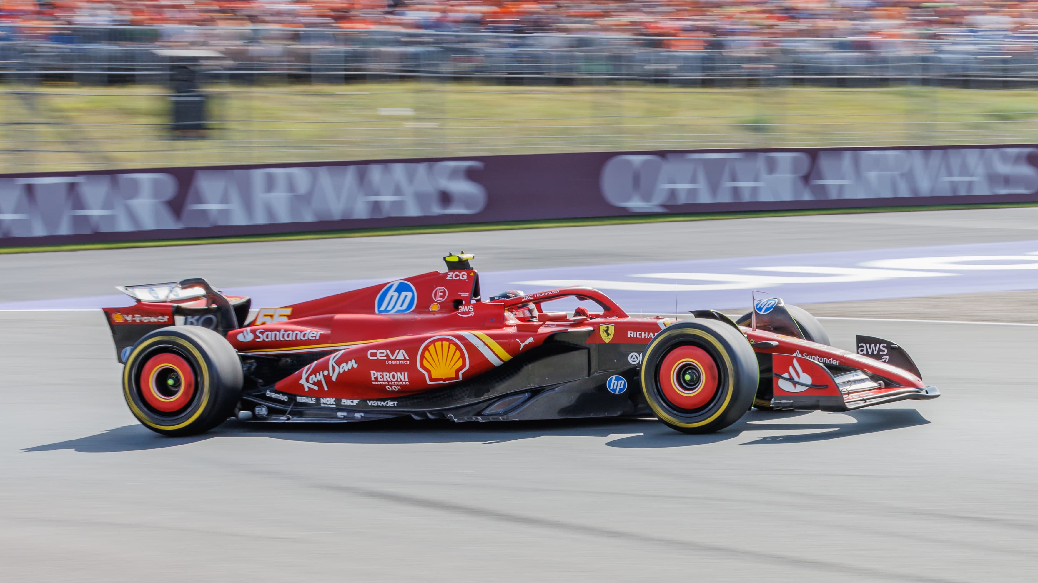 Carlos Sainz driving a red Ferrari Formula 1 car at speed during the 2024 Dutch Grand Prix