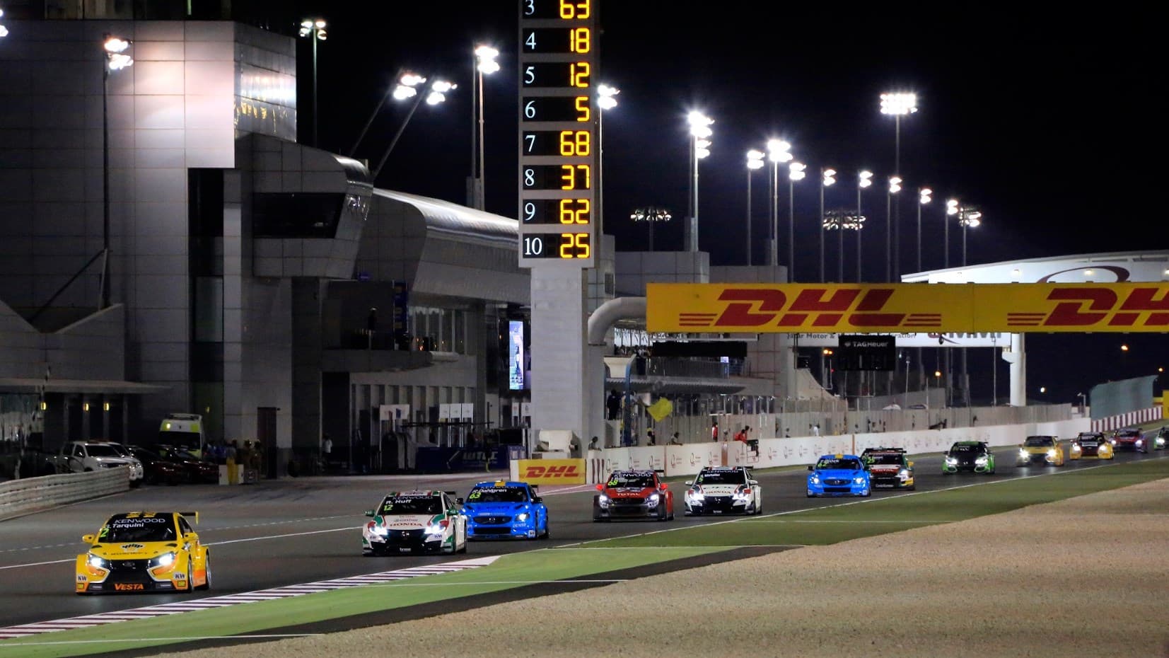 Touring cars racing under floodlights at Lusail International Circuit in Qatar