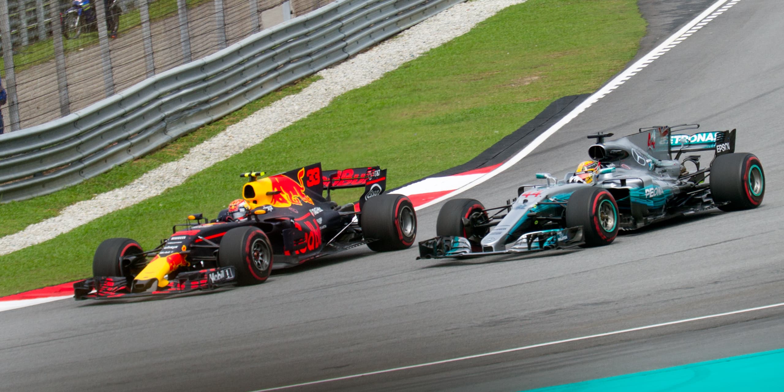 Max Verstappen overtaking Lewis Hamilton during the 2017 Malaysian Grand Prix at Sepang International Circuit