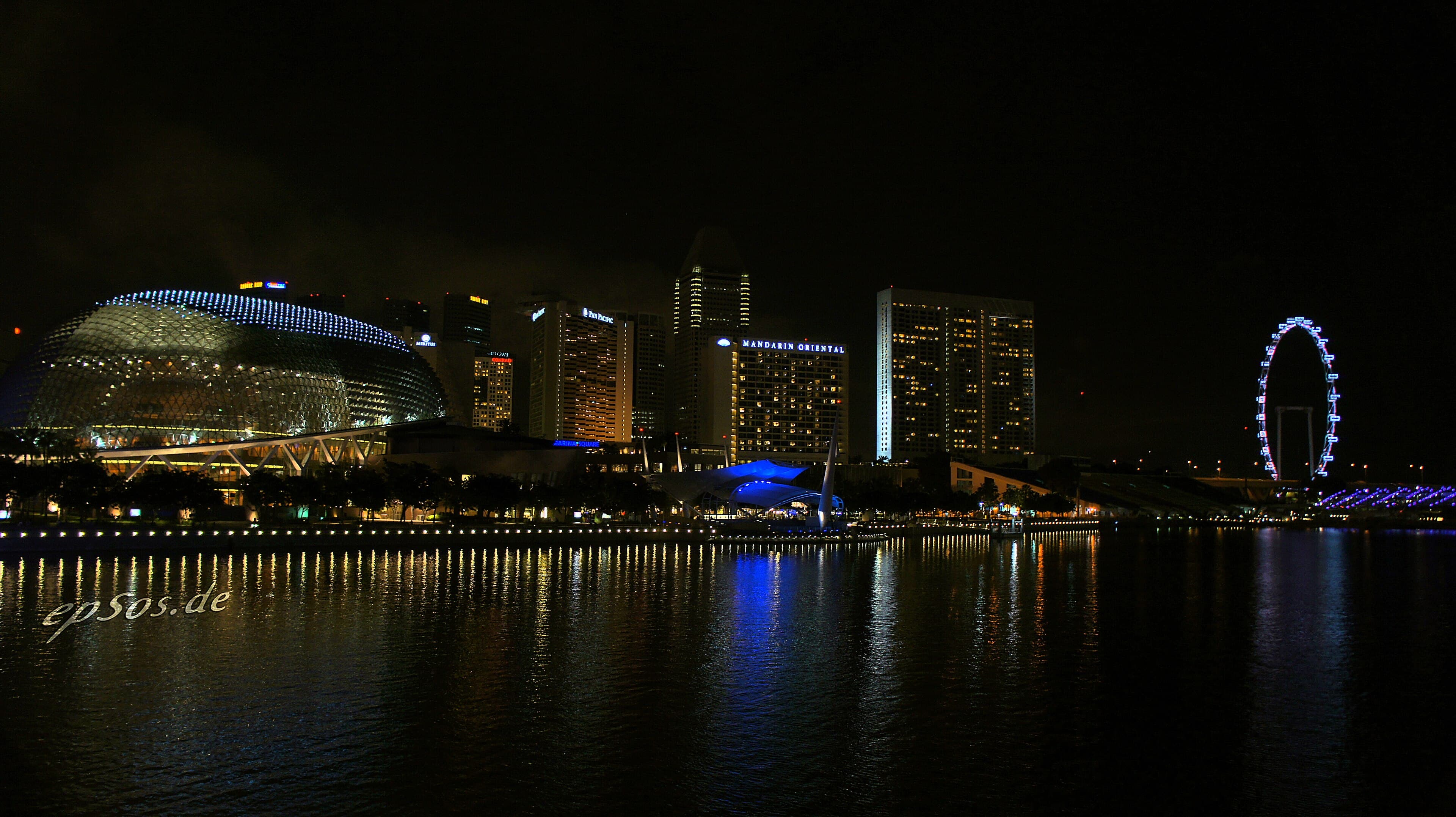 Marina Bay illuminated at night with the Esplanade and Singapore Flyer beside the waterfront